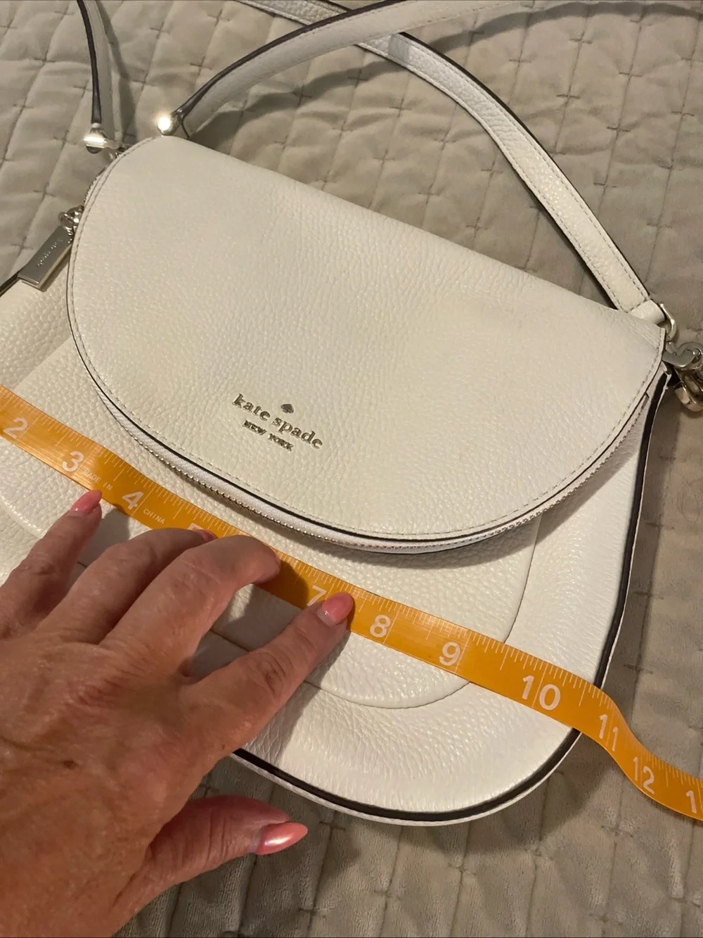 kate spade cream pebbled leather crossbody with gold logo